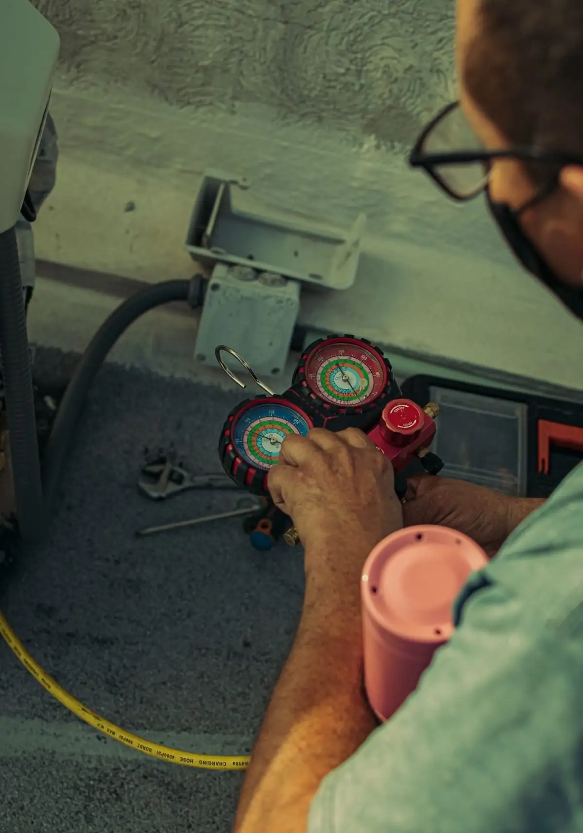 Refrigerant manifold gauges read during a Bronx service call